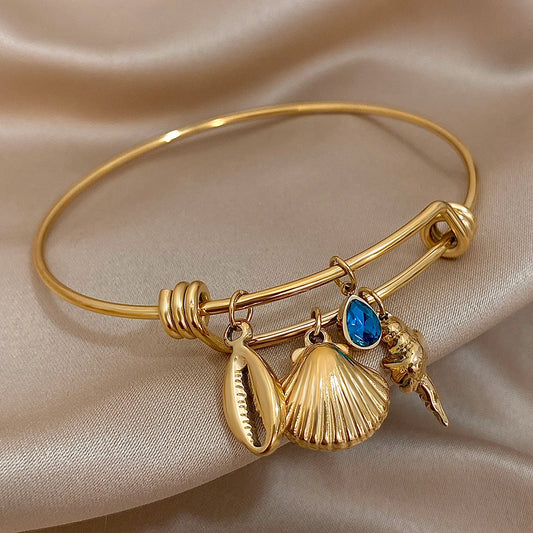 Gold Conch Shell Charm Bangle